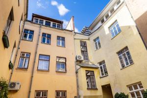 a large yellow building with many windows at Old Town Hearh Light and Open Modern Flat VIP in Klaipėda +3 photos