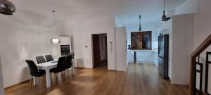 a living room with a table and chairs and a kitchen at Villa MISTRAL przy plaży in Sława