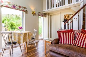 a living room with a couch and a table at Cruickshanks Boutique B&B in Whiting Bay