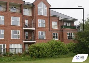 a large red brick building with a window at Luke Stays - Roundhaven in Brandon