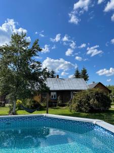 a swimming pool in front of a house at Myczkowianka Sadyba in Uherce Mineralne (7)