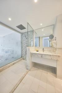 a bathroom with a large sink and a large mirror at Golden Palace Marina Hotel in El Alamein