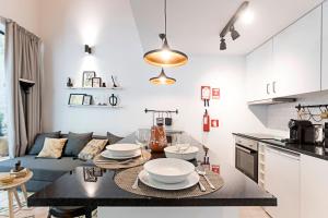 a kitchen and living room with a table and a couch at Vila Terra Luxury Apartments I in Vila Nova de Gaia