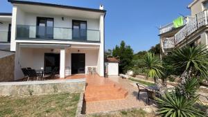 a large white house with chairs and a staircase at VILLA HOLIDAY in Banjole
