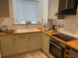 a kitchen with a sink and a counter top at Little House in Porlock