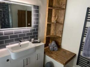a bathroom with a sink and a mirror at Little House in Porlock
