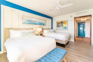 a bedroom with two beds and a ceiling fan at Margaritaville Resort Orlando in Orlando