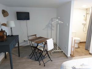 Cette chambre comprend un bureau, une table et une chaise. dans l'établissement Quinta da Ponte, à Viana do Castelo