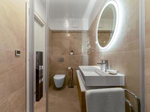 a bathroom with a white sink and a mirror at Diamond two bedroom apartment in Zadar +51 photos