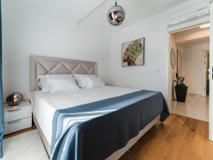 a bedroom with a large bed with a blue blanket at Diamond two bedroom apartment in Zadar