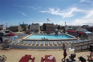 a large swimming pool in a building with people in it at Sea Spray Motel in Beach Haven