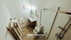 a small bathroom with a toilet and a sink at Beach Residence Mar do Norte in Ribamar