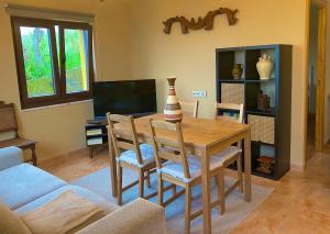 a dining room with a wooden table and chairs at La Pedrosa in Fontanina