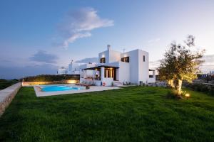 a large white house with a swimming pool in a yard at Villa Salamina in Lachania