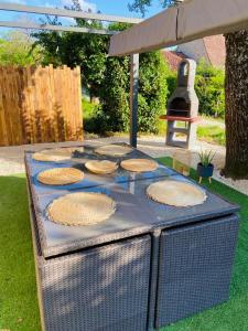 a grill with pies on top of it in a yard at Proche SARLAT le gîte de FANOVA in Marcillac-Saint-Quentin