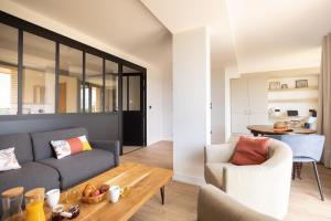 a living room with a couch and a table at La Bergerie Yves Rocher in La Gacilly