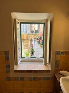 a window in a bathroom with a view of a street at The Heart of Hvar in Hvar