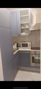 a kitchen with a white refrigerator and a microwave at Apartment Zittera - Adults only in Innsbruck