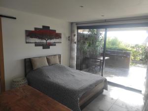a bedroom with a bed and a sliding glass door at Studio Villa Le M in Six-Fours-les-Plages
