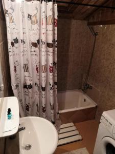 a bathroom with a toilet and a shower curtain at Cabana Taul Brazilor in Roşia Montană