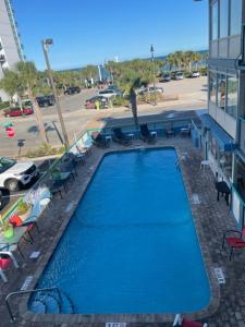 a large blue swimming pool next to a building at Ocean 5 Hotel in Myrtle Beach