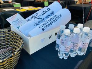 a box of water bottles on a table with a basket at Xisaka Guest House in Giyani