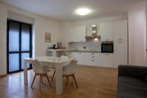 a kitchen and dining room with a table and chairs at Casa vacanze san salvo centro in San Salvo