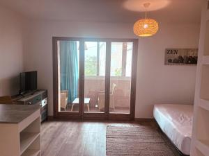 a bedroom with a bed and a sliding glass door at Studio Roncu in Calvi