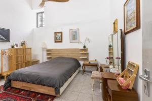 a bedroom with a bed and a desk and a table at To Hani - Large Traditional House in Nicosia