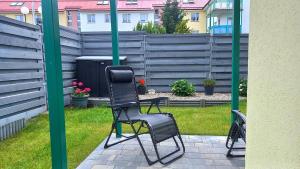 a pair of black chairs sitting on a patio at Apartament Marco in Koszalin