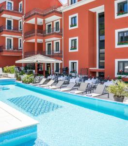 a row of red and white swimming pools in a building at Hotel Cvita in Split