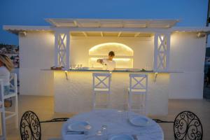 a man standing at a counter in a kitchen at Cesurlar Hotel in Çeşme