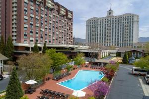 a hotel swimming pool with chairs and a large building at Little America Hotel Salt Lake City in Salt Lake City