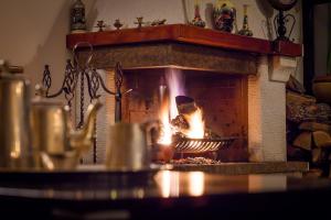 a person baking food in a brick oven at Pension Pantheon in Poiana Brasov