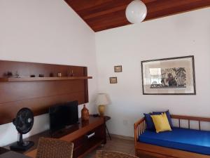 sypialnia z łóżkiem i biurkiem z telewizorem w obiekcie PARAÍSO - ACONCHEGANTE - PRÁTICO E PRÓXIMO DE TUDO w mieście Cabo Frio