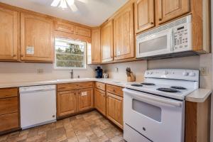 a kitchen with white appliances and wooden cabinets at Rainey 5577 in Orange Park