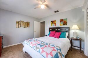 a bedroom with a large bed with colorful pillows at Rainey 5577 in Orange Park
