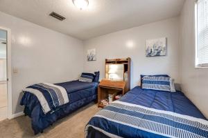 a bedroom with two beds and a mirror at Rainey 5577 in Orange Park