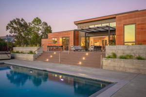 a house with a swimming pool in front of it at Xanadu Healdsburg A Wine Country Escape in Healdsburg