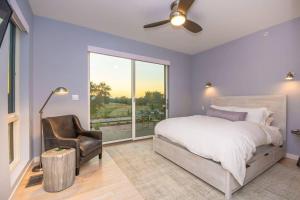 a bedroom with a bed and a chair and a window at Xanadu Healdsburg A Wine Country Escape in Healdsburg +35 photos