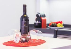a bottle of wine and two wine glasses on a counter at Seaview modern beach apartment in Guardamar del Segura