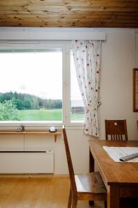 d'une salle à manger avec une table et une fenêtre. dans l'établissement Mummon mökki - Granny´s cottage, à Suonenjoki