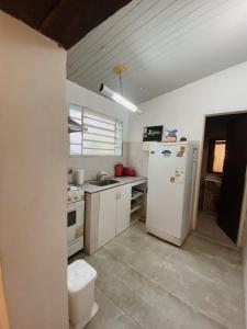 a kitchen with white appliances and a white refrigerator at Garden Loft in Rosario