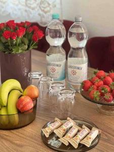 a table with fruit and bottles of milk and cookies at Ferienwohnung Falke in Meckenbeuren