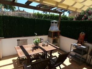 a wooden table and chairs sitting on a patio at Casa Bella Castell d Aro in Castillo de Aro