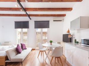 a living room with a white couch and a table at Guadiana · Apartment 2x1, near Sants station in Barcelona