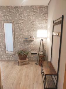 a room with a mirror and a chair and a table at Centro Loft 2.0 in Oviedo