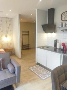 a kitchen and living room with a couch and a table at Centro Loft 2.0 in Oviedo