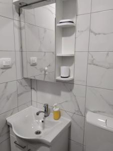 a white bathroom with a sink and a mirror at Blue harmony 1 Malinska in Malinska +29 photos