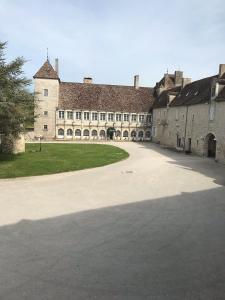 a large stone building with a large courtyard at Château de la Berchère in Nuits-Saint-Georges +10 photos